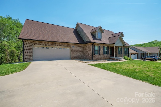 1592 Farmington Hills Dr, Conover, NC 28613 - new england style home featuring concrete driveway, a front lawn, a shingled roof, a garage, and brick siding