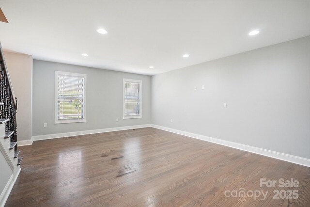 1592 Farmington Hills Dr, Conover, NC 28613 - unfurnished living room featuring stairway, baseboards, wood finished floors, and recessed lighting