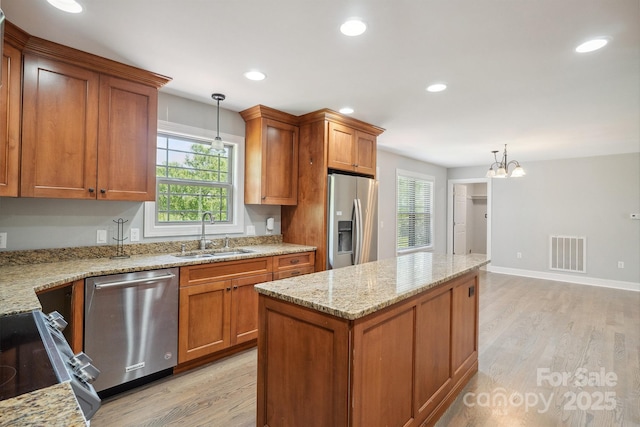 1592 Farmington Hills Dr, Conover, NC 28613 - kitchen featuring light wood-style flooring, a sink, plenty of natural light, visible vents, and appliances with stainless steel finishes