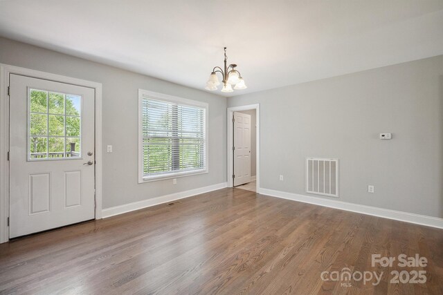 1592 Farmington Hills Dr, Conover, NC 28613 - unfurnished dining area featuring baseboards, wood finished floors, visible vents, and a chandelier