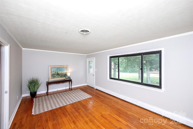 134 Piedmont Dr, Kannapolis, NC 28081 - entryway featuring wood finished floors, visible vents, baseboards, and ornamental molding