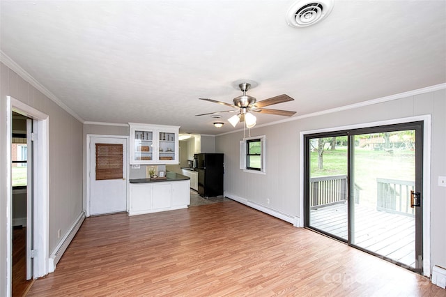 134 Piedmont Dr, Kannapolis, NC 28081 - unfurnished living room featuring a baseboard radiator, crown molding, and visible vents