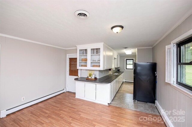 134 Piedmont Dr, Kannapolis, NC 28081 - kitchen featuring open shelves, visible vents, light wood-style floors, and a baseboard radiator