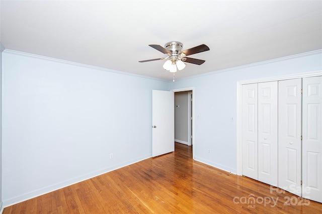134 Piedmont Dr, Kannapolis, NC 28081 - unfurnished bedroom featuring light wood-style flooring, baseboards, a closet, ceiling fan, and ornamental molding