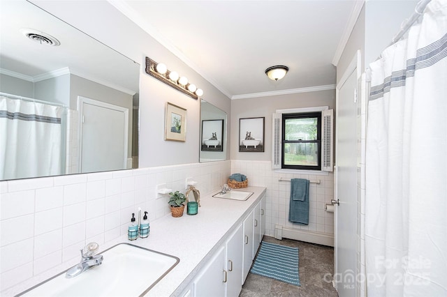 134 Piedmont Dr, Kannapolis, NC 28081 - bathroom featuring crown molding, a sink, tile walls, double vanity, and visible vents