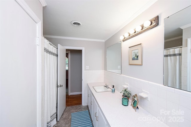 134 Piedmont Dr, Kannapolis, NC 28081 - bathroom featuring ornamental molding, vanity, visible vents, and tile walls