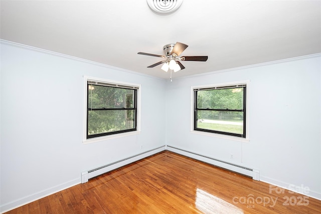 134 Piedmont Dr, Kannapolis, NC 28081 - unfurnished room featuring a baseboard heating unit, crown molding, wood finished floors, and visible vents