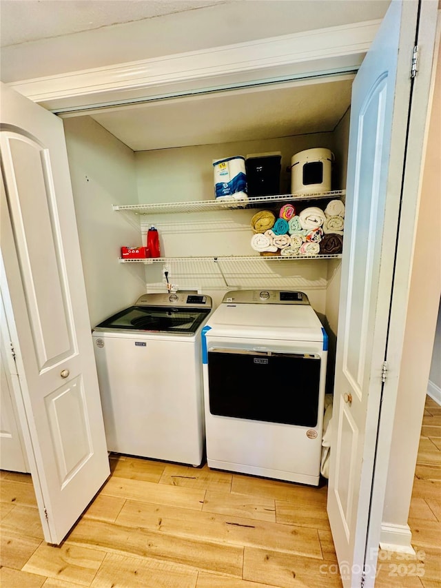 washroom featuring independent washer and dryer and light wood-style floors