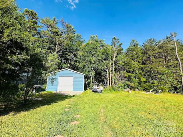 view of grassy yard with an outdoor structure and a garage