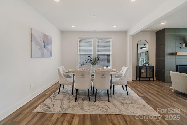 dining room featuring wood finished floors, recessed lighting, and baseboards
