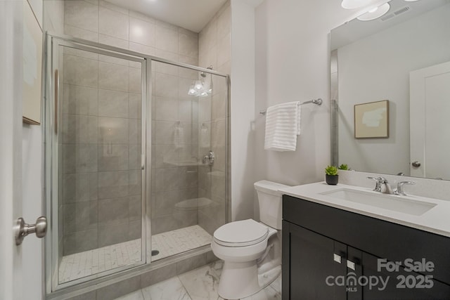 bathroom featuring a shower stall, vanity, marble finish floor, toilet, and visible vents
