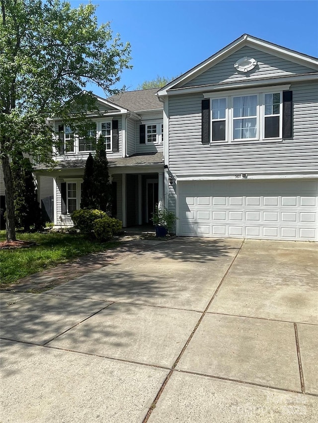 traditional-style home featuring concrete driveway and an attached garage