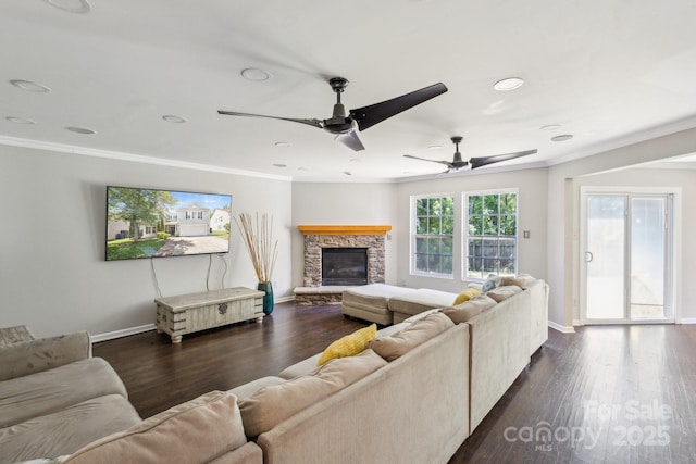 5611 Hammermill Dr, Harrisburg, NC 28075 - living area featuring crown molding, baseboards, a stone fireplace, dark wood finished floors, and recessed lighting