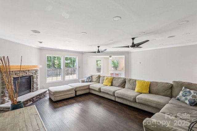 5611 Hammermill Dr, Harrisburg, NC 28075 - living area with wood finished floors, ornamental molding, a stone fireplace, a ceiling fan, and recessed lighting