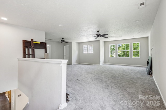 5611 Hammermill Dr, Harrisburg, NC 28075 - unfurnished living room featuring a ceiling fan, carpet flooring, baseboards, a textured ceiling, and recessed lighting