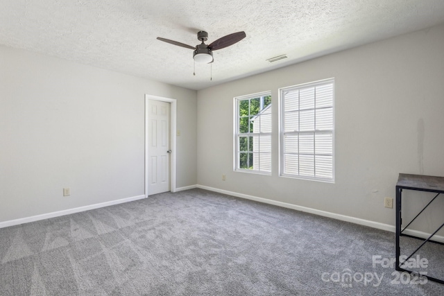 5611 Hammermill Dr, Harrisburg, NC 28075 - carpeted empty room with a textured ceiling, baseboards, and a ceiling fan
