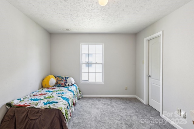 5611 Hammermill Dr, Harrisburg, NC 28075 - carpeted bedroom featuring a textured ceiling and baseboards