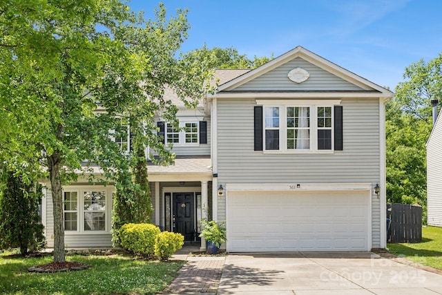 5611 Hammermill Dr, Harrisburg, NC 28075 - traditional-style house with driveway, a garage, roof with shingles, and fence