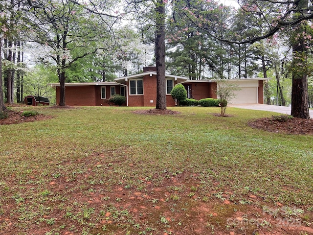 ranch-style house with brick siding, a chimney, driveway, a front yard, and an attached garage