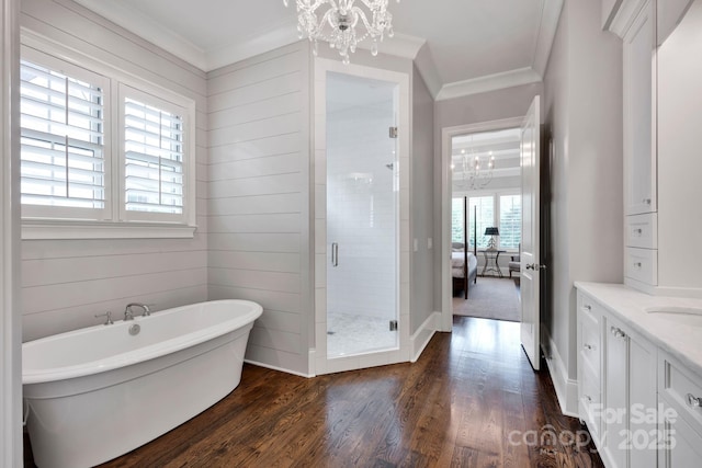17909 Golden Meadow Ct, Davidson, NC 28036 - full bathroom featuring a chandelier, a shower stall, crown molding, a soaking tub, and wood finished floors