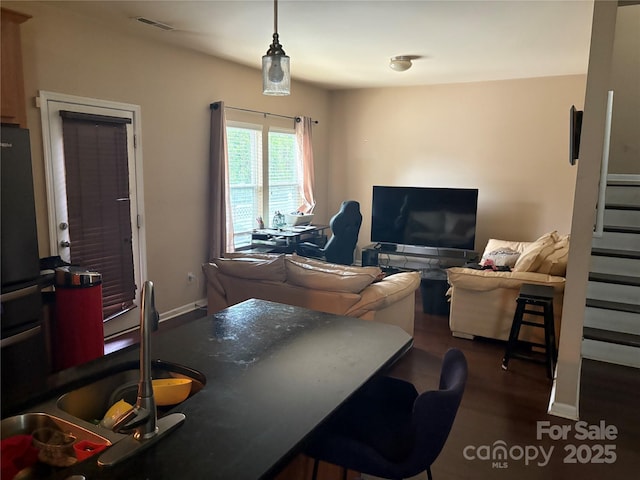 1104 Valley St, Statesville, NC 28677 - living area featuring wood finished floors and stairs