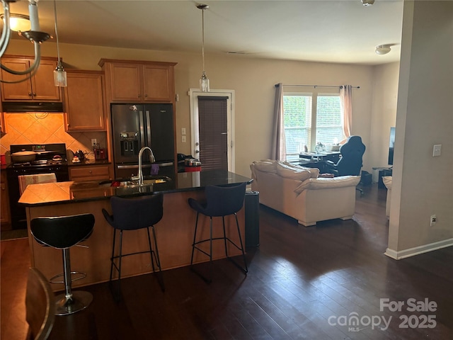 1104 Valley St, Statesville, NC 28677 - kitchen with fridge with ice dispenser, black electric range oven, under cabinet range hood, a sink, and dark countertops