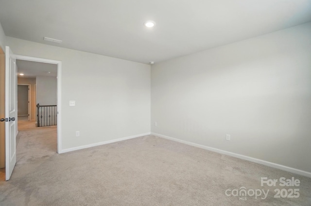 unfurnished room with recessed lighting, light colored carpet, and baseboards