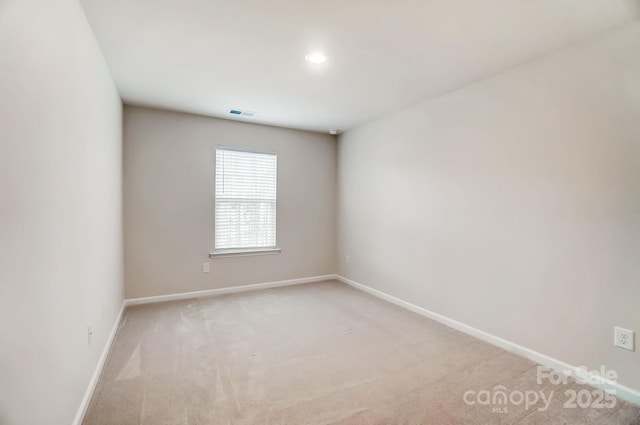 empty room featuring recessed lighting, visible vents, baseboards, and carpet floors