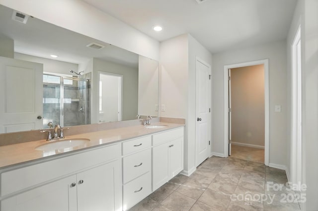 bathroom featuring a sink, visible vents, a shower stall, and double vanity