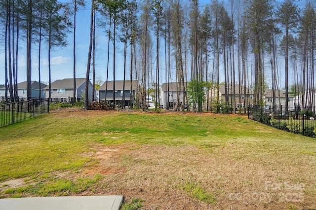 view of yard featuring a residential view and fence