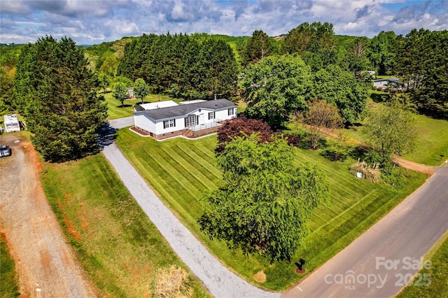 birds eye view of property with a wooded view