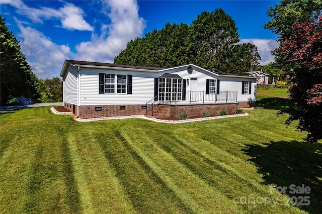 manufactured / mobile home with a front lawn and crawl space