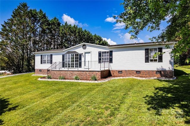 manufactured / mobile home featuring a front yard and crawl space