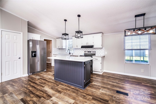 kitchen with white cabinetry, stainless steel appliances, and light countertops