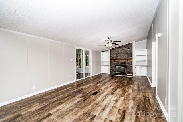 unfurnished living room featuring dark wood-style floors, a fireplace, ceiling fan, built in features, and vaulted ceiling