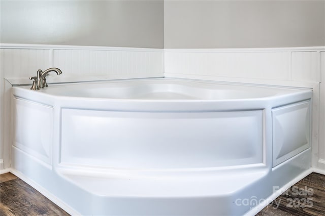 bathroom featuring wainscoting and wood finished floors