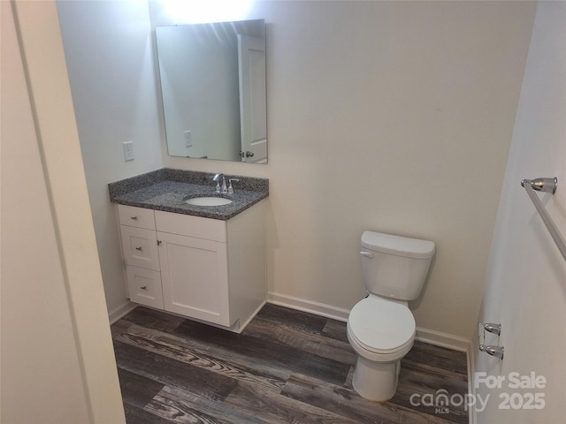 405 N Mulberry St, Cherryville, NC 28021 - bathroom featuring toilet, wood finished floors, vanity, and baseboards