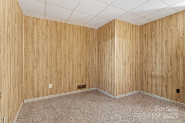 3670 Maple Creek Rd, Rutherfordton, NC 28139 - empty room with a drop ceiling, carpet, wooden walls, and baseboards