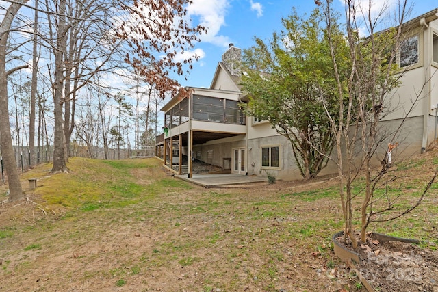3670 Maple Creek Rd, Rutherfordton, NC 28139 - rear view of property with a sunroom, a chimney, a patio, a lawn, and french doors