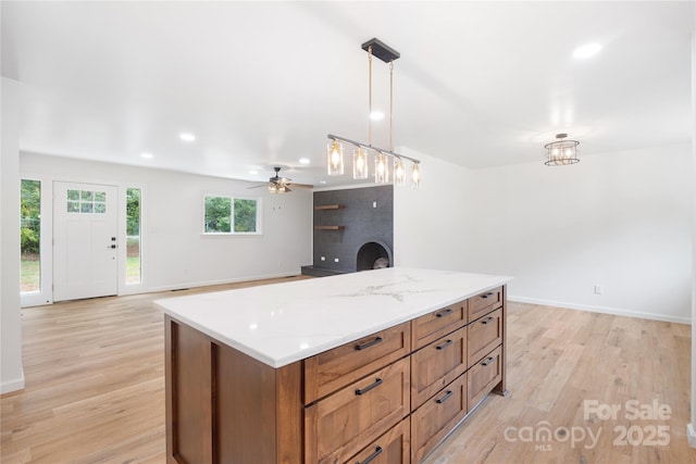 1904 27th Avenue Dr NE, Hickory, NC 28601 - kitchen featuring light wood finished floors, brown cabinets, pendant lighting, ceiling fan, and recessed lighting