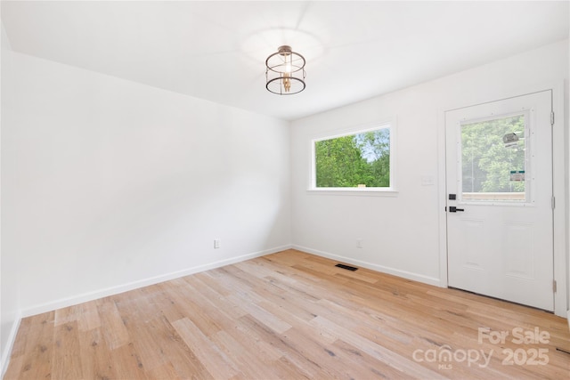1904 27th Avenue Dr NE, Hickory, NC 28601 - unfurnished dining area featuring light wood-style floors, baseboards, and a chandelier