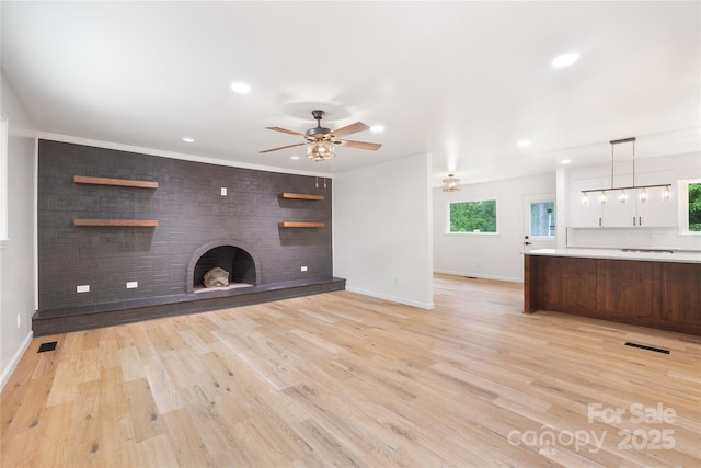 1904 27th Avenue Dr NE, Hickory, NC 28601 - unfurnished living room with a fireplace, baseboards, ceiling fan, recessed lighting, and light wood-style floors