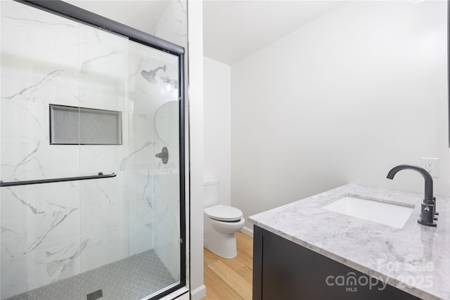 1904 27th Avenue Dr NE, Hickory, NC 28601 - bathroom with toilet, wood finished floors, a marble finish shower, and vanity