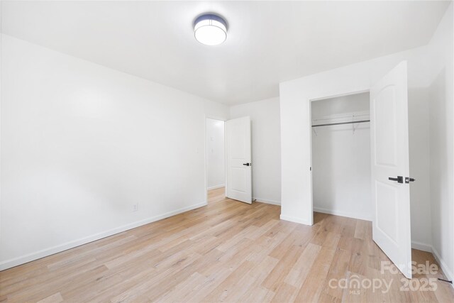 1904 27th Avenue Dr NE, Hickory, NC 28601 - unfurnished bedroom with light wood-style floors, baseboards, and a closet