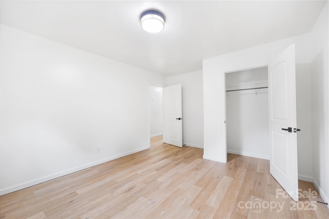 1904 27th Avenue Dr NE, Hickory, NC 28601 - unfurnished bedroom with light wood-style floors, baseboards, and a closet