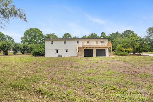 1904 27th Avenue Dr NE, Hickory, NC 28601 - rear view of house featuring an attached garage, a wooden deck, central AC unit, a yard, and stairway