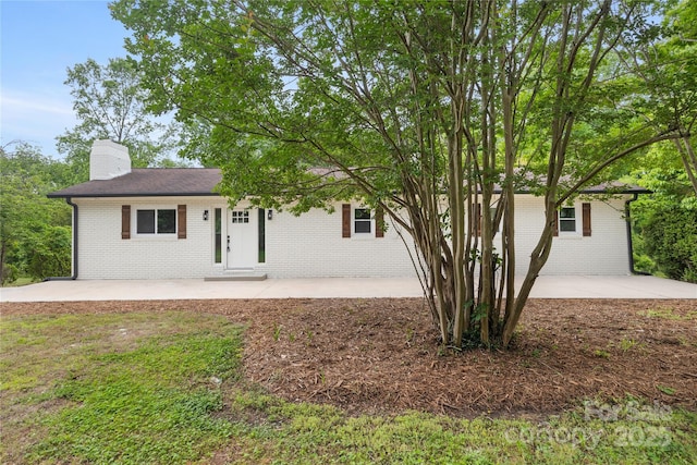 1904 27th Avenue Dr NE, Hickory, NC 28601 - ranch-style home featuring brick siding, a patio area, and a chimney