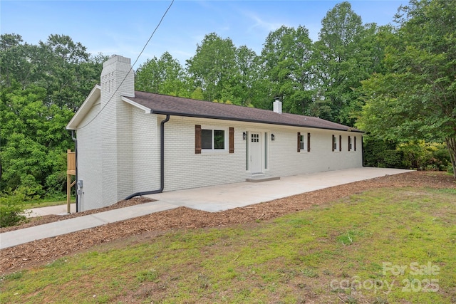 1904 27th Avenue Dr NE, Hickory, NC 28601 - ranch-style home featuring a chimney, a patio area, brick siding, and a front yard