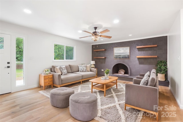 1904 27th Avenue Dr NE, Hickory, NC 28601 - living area featuring light wood-style flooring, a brick fireplace, a ceiling fan, baseboards, and recessed lighting