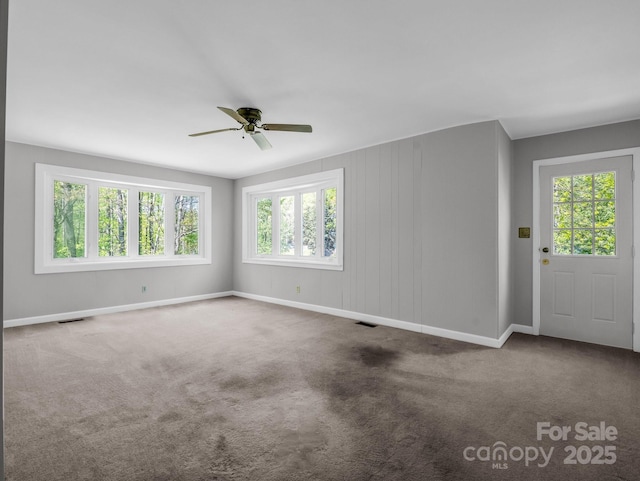 spare room with ceiling fan, baseboards, and visible vents